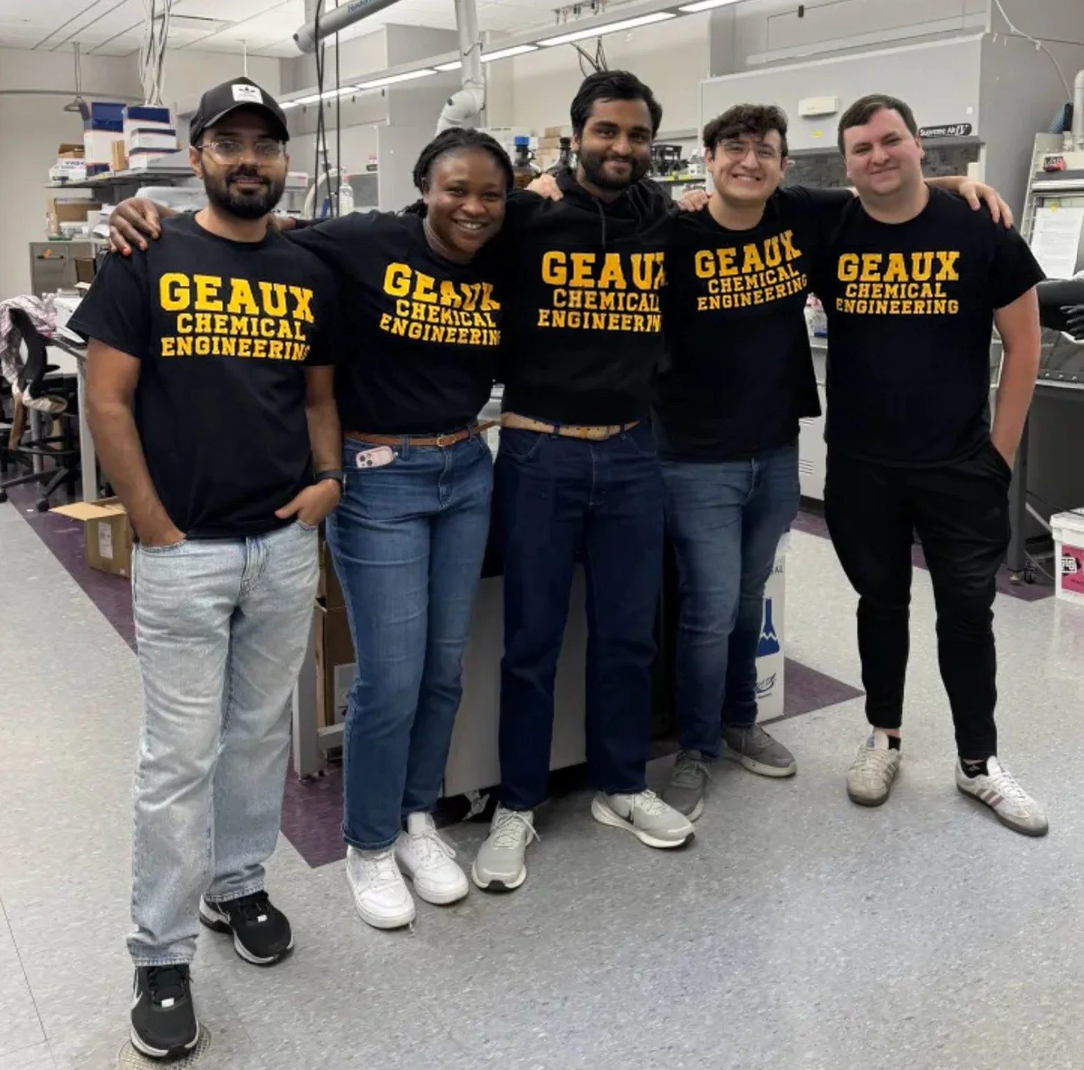 Group members in Geaux Chemical Engineering shirts in the lab.