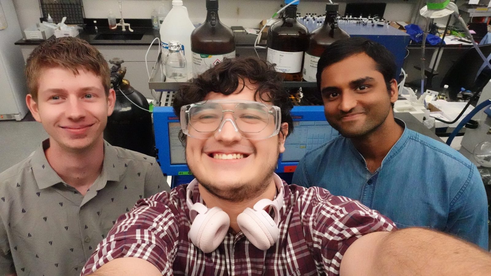 Three group members in the lab.